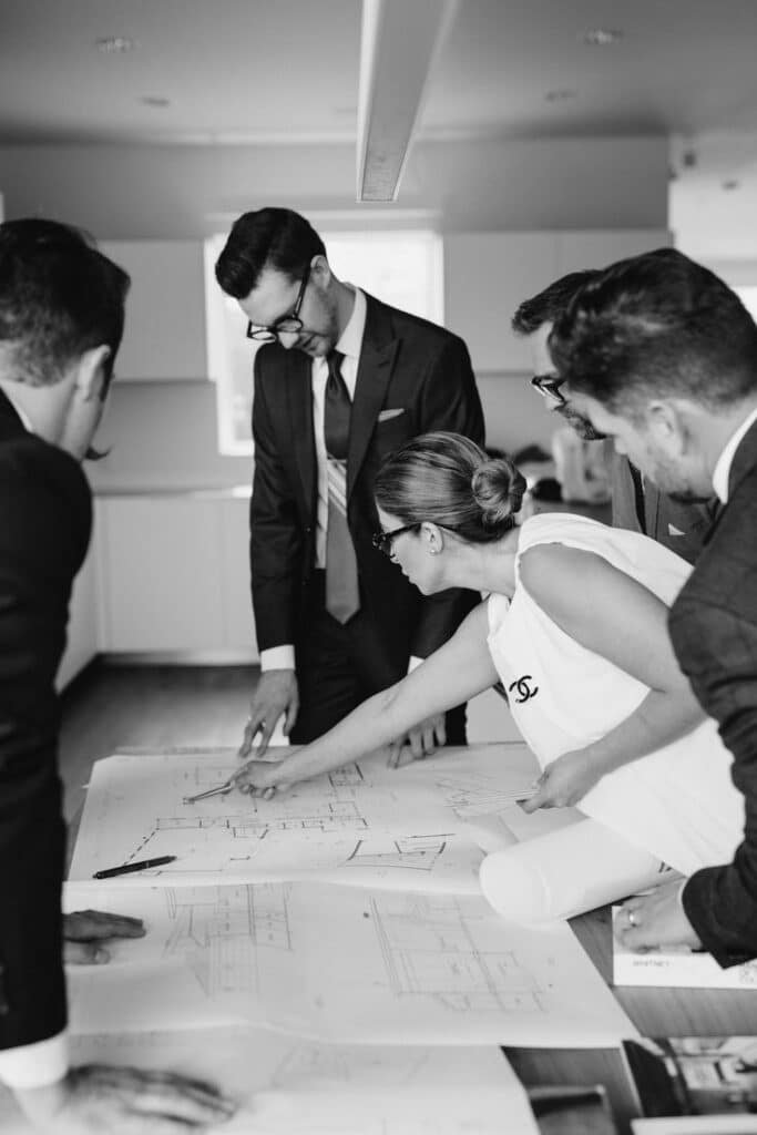 Team collaborating over architectural blueprints at a conference table.