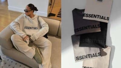 Person in cozy Essentials sweater set on couch; four folded Essentials shirts in neutral colors displayed nearby.
