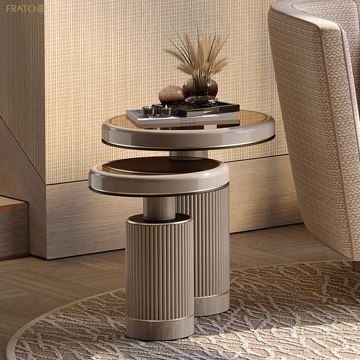 Elegant round side table with books and decor elements, placed beside a textured armchair in a modern living room.