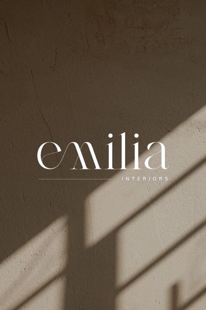 Elegant Emilia Interiors logo on textured beige background with diagonal shadow lines.