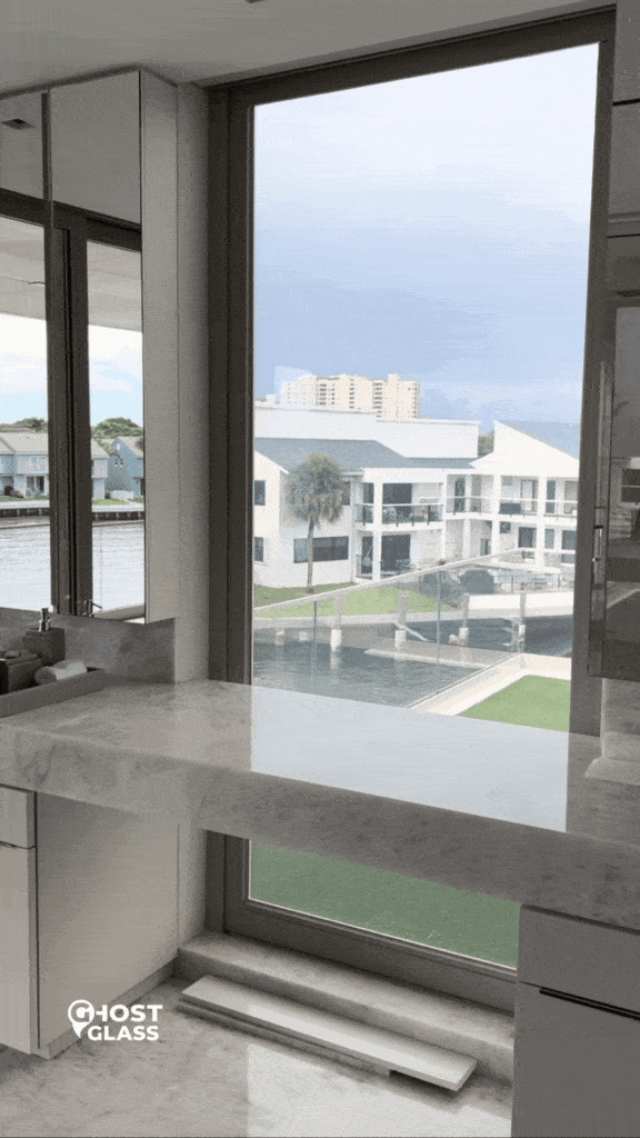 Modern bathroom with large window, canal view, and marble countertop. Perfect blend of luxury and functionality.