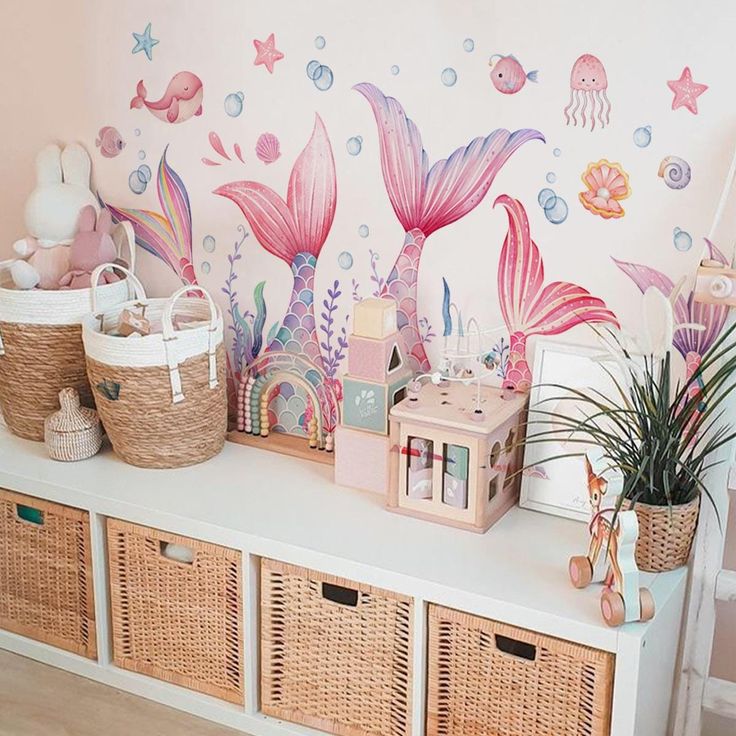 Whimsical mermaid-themed nursery with pastel decor, wicker baskets, and colorful toys. Perfect for kids' room inspiration.