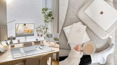 Stylish minimalist workspace with computer and plant, cozy setup with coffee and notebook on a soft chair.