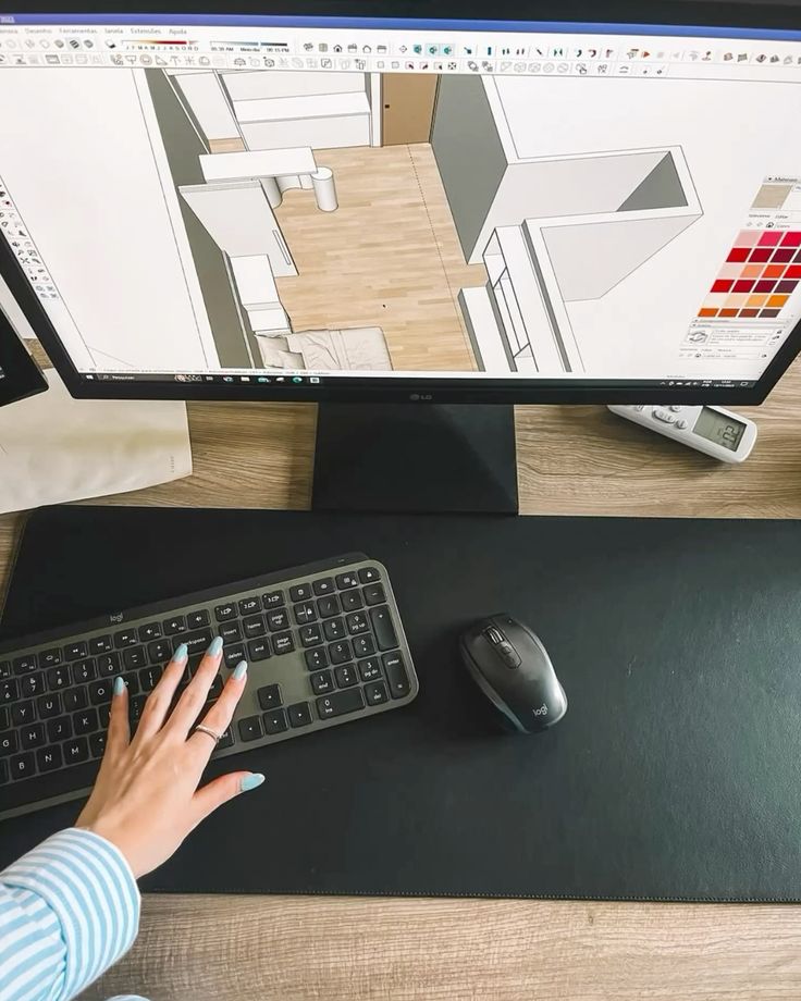 Hallie Hart Person using design software on a computer, keyboard and mouse on desk. | Sky Rye Design Person using design software on a computer, keyboard and mouse on desk.