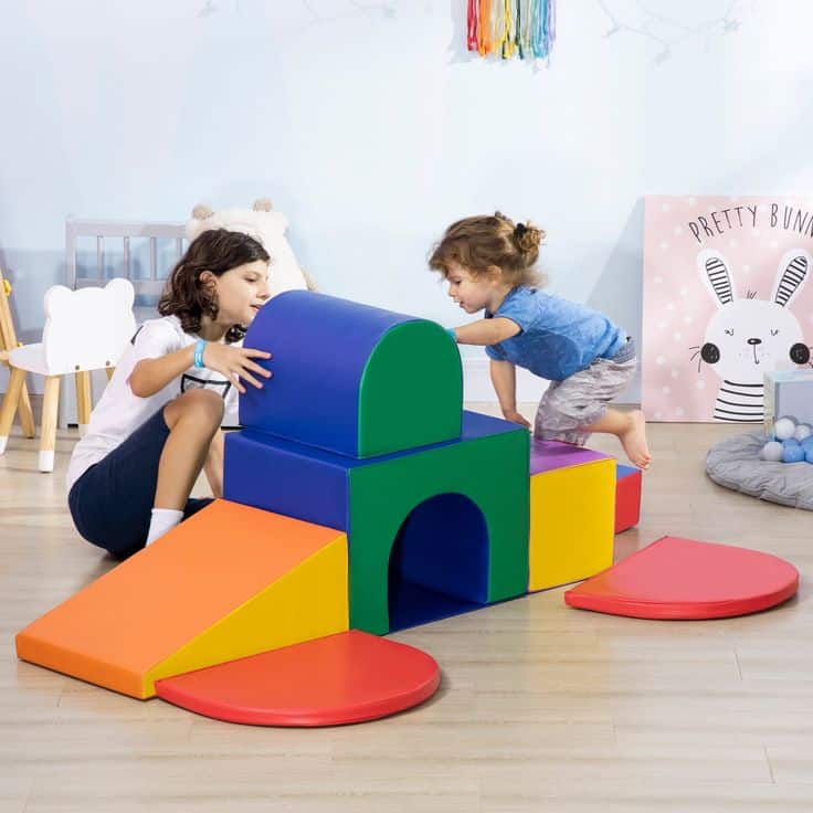 Children playing with colorful foam blocks in a playroom.