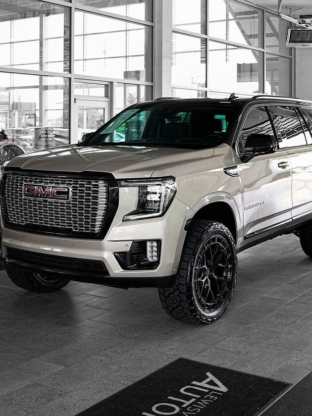 Instagram Luxury white SUV parked indoors, showcasing sleek design and large tires. | Sky Rye Design Luxury white SUV parked indoors, showcasing sleek design and large tires.