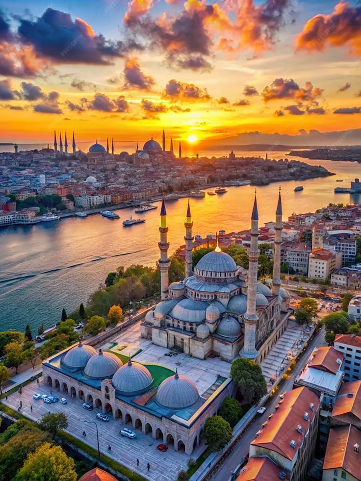 Sunset over Istanbul's skyline and historic mosque, with vibrant skies reflecting on the Bosphorus Strait.