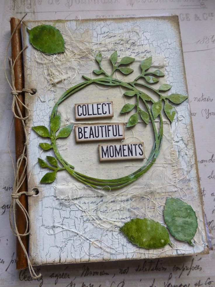 Decorative journal with green leaf accents and Collect Beautiful Moments text on cover. Vintage-style design.
