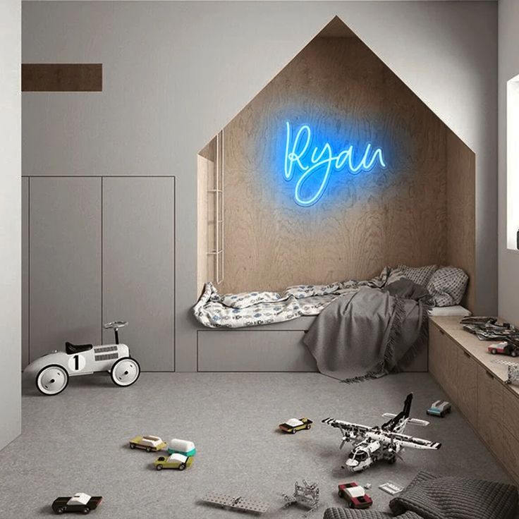 Modern kids' room with cozy bed nook, neon name sign, and scattered toys on the floor.