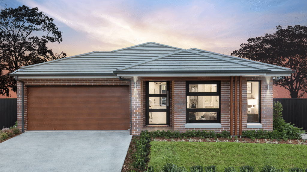Modern brick house with a spacious driveway and garage at sunset. Lush garden in the front yard.