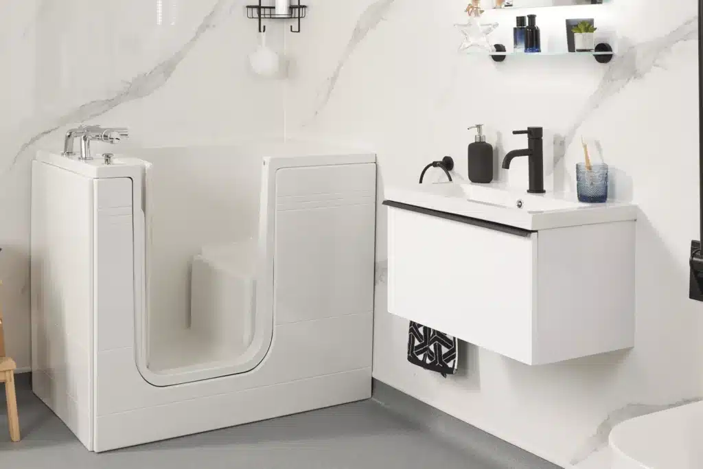 Accessible bathroom with walk-in bathtub, modern sink, and shelves. Ideal for seniors or mobility-challenged individuals.