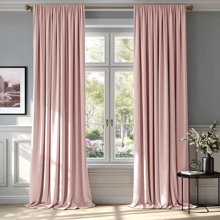 Elegant pink curtains frame a sunny garden view through a window in a stylishly decorated room.