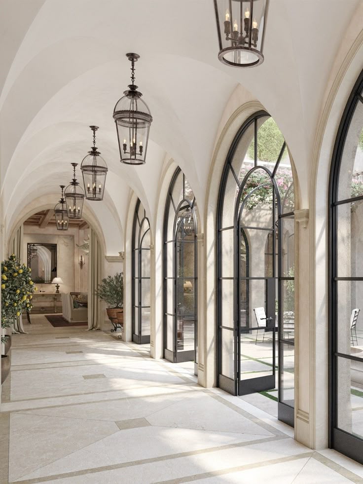 Luxurious corridor with arched windows, elegant lanterns, and natural light creating a serene atmosphere.
