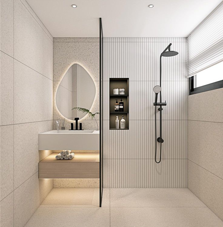 Modern minimalist bathroom with sleek shower, illuminated mirror, and stylish toiletries shelf.