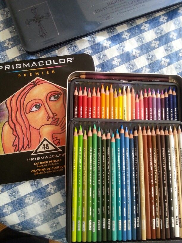 Prismacolor Premier 48 colored pencils set displayed on a checkered tablecloth.