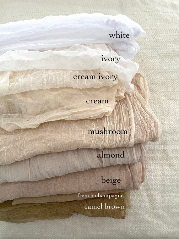 Stack of fabric swatches labeled: white, ivory, cream ivory, cream, mushroom, almond, beige, french champagne, camel brown.