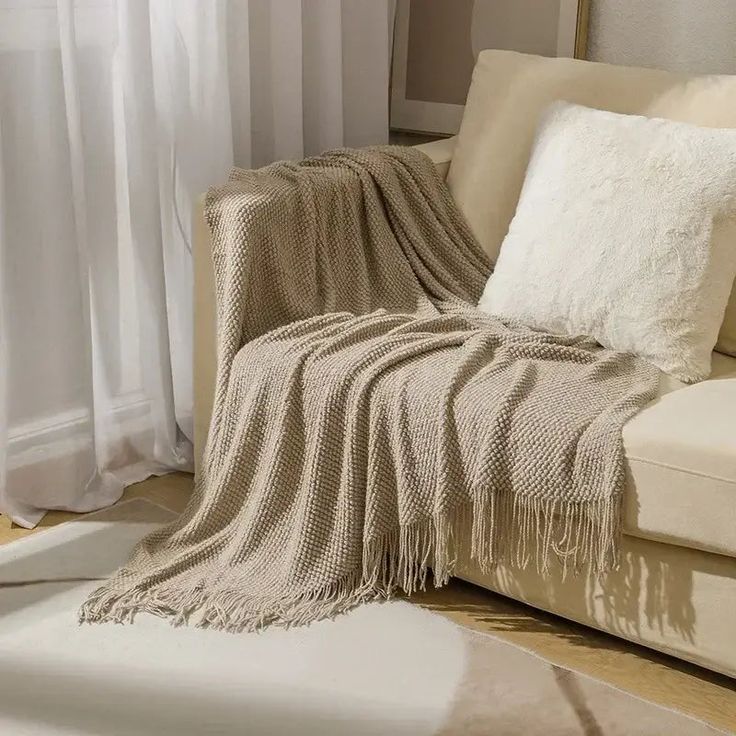 Nordic Style Knitted Throw - Coral _ 130x230cm Cozy beige living room with knit throw blanket and plush pillow on cream sofa, with soft sunlight filtering in through curtains. | Sky Rye Design Cozy beige living room with knit throw blanket and plush pillow on cream sofa, with soft sunlight filtering in through curtains.