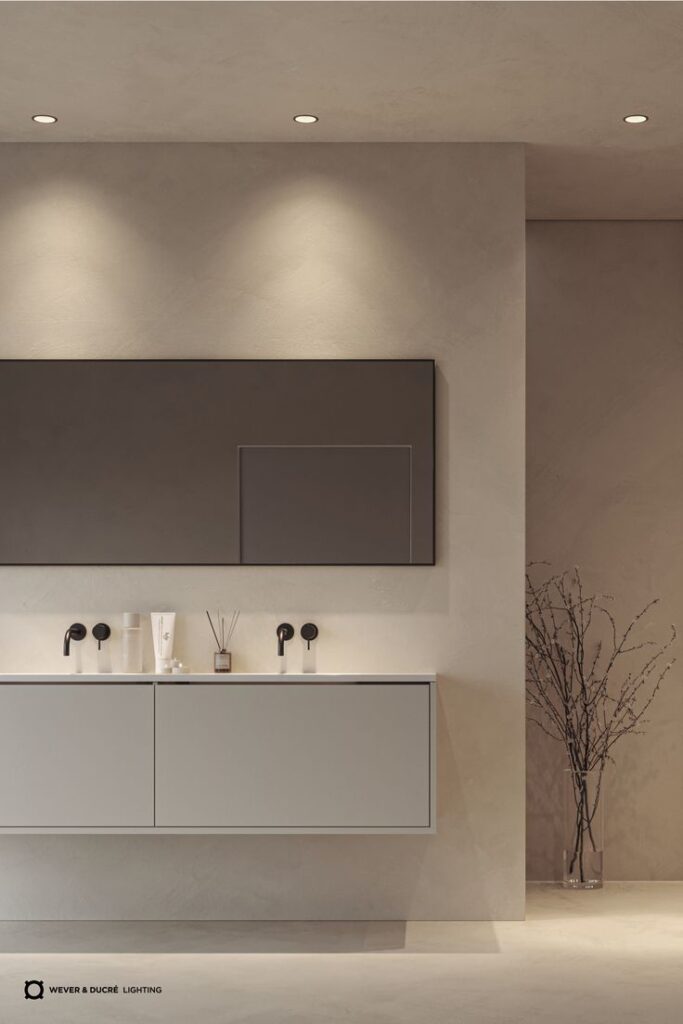 Modern bathroom with sleek vanity, large mirror, and soft lighting, creating a minimalist and elegant design.