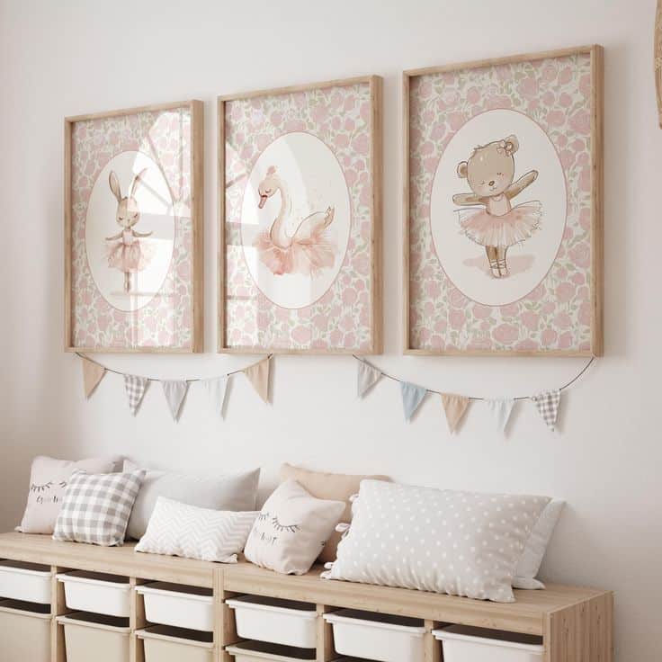 Three framed animal ballerina prints in a child's room, above cushioned seating with decorative bunting.