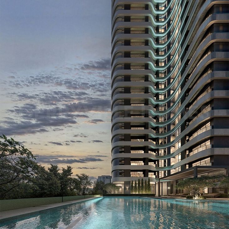 Step into the future of urban living with Modern high-rise building with illuminated windows and reflection in a swimming pool at dusk. | Sky Rye Design Modern high-rise building with illuminated windows and reflection in a swimming pool at dusk.