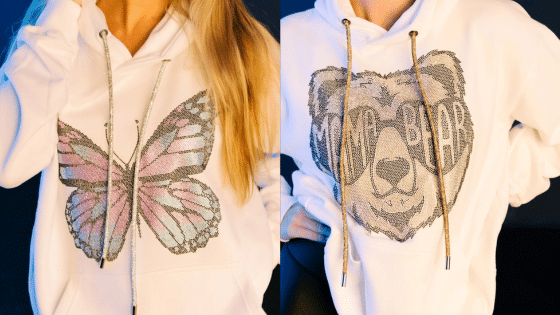 Streetwear Meets Sparkle Why Rhinestone Hoodies Are the New Power Piece Two white hoodies with sequin designs: one features a colorful butterfly, the other a bear with mama bear text. | Sky Rye Design Two white hoodies with sequin designs: one features a colorful butterfly, the other a bear with mama bear text.