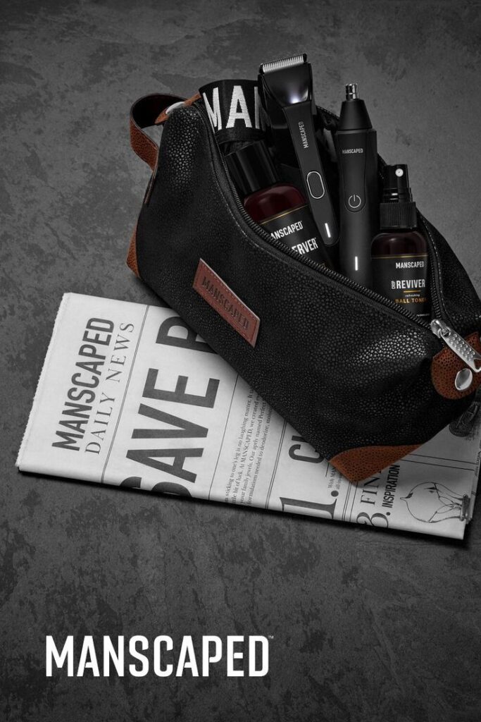 Manscaped grooming kit on a newspaper, featuring trimmers and skincare products in a sleek black toiletry bag.