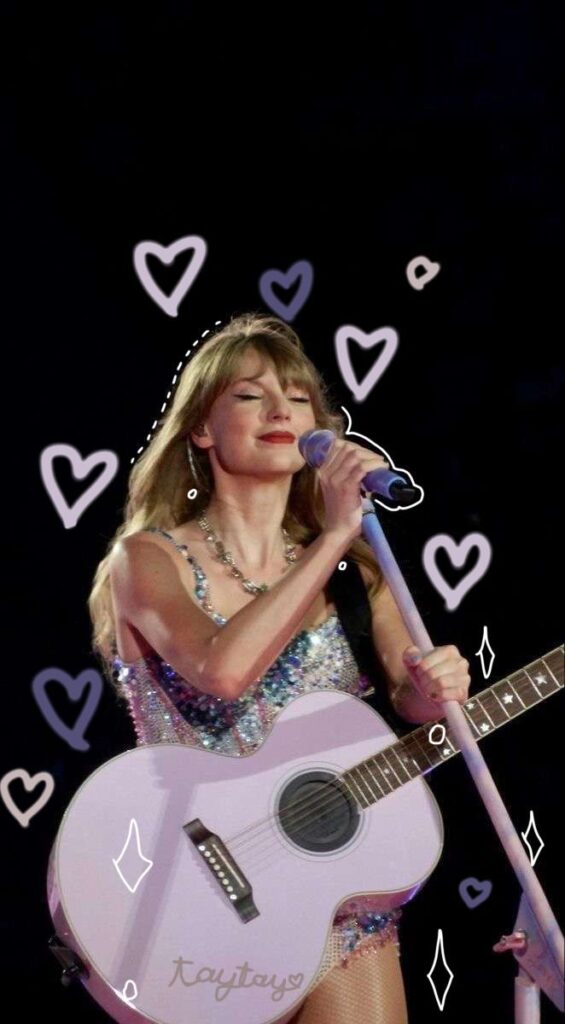 Singer performing with guitar on stage, surrounded by doodle hearts, wearing a shimmering outfit.