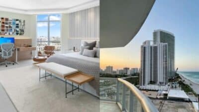 Modern bedroom with desk and city view, beside a balcony overlooking beachfront high-rise buildings at sunset.