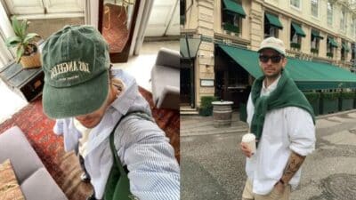 Casual urban fashion: person in cap and sunglasses with coffee, outside cafe with green awnings, wearing casual attire.