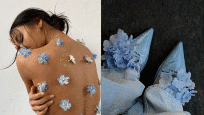 Person adorned with blue flowers on skin, alongside pale blue floral heels and jeans, showcasing creative fashion styling.