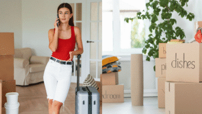 Young woman with suitcase on phone during a home move, surrounded by labeled boxes and plants.
