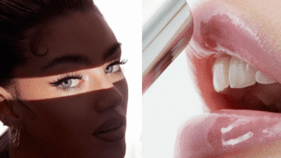 Close-up of a woman with bold makeup and glossy lips, showcasing a striking eye and lip detail in natural light.