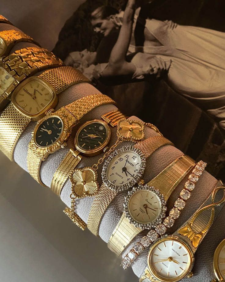 Collection of elegant gold and silver wristwatches displayed on a roll, featuring various styles and bracelets.