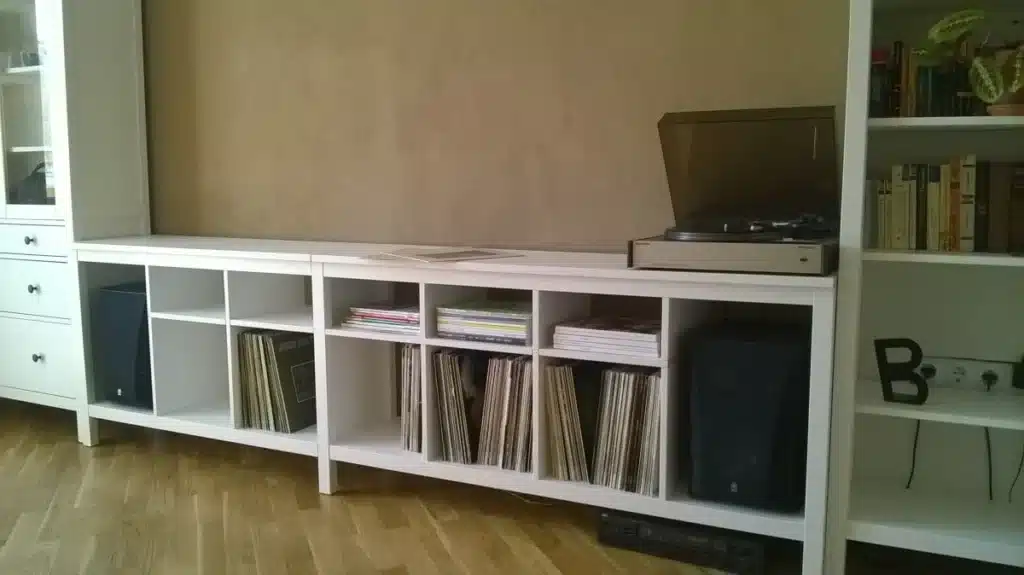 White shelving unit with vinyl records and a turntable, perfect for a stylish living room music corner.