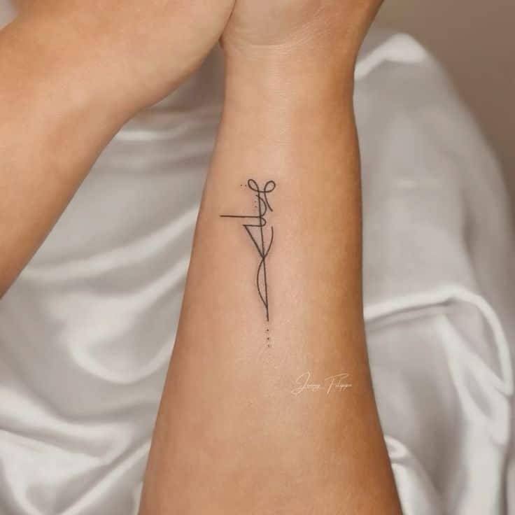 Minimalist script tattoo on a forearm with elegant, thin lines, against a soft background.