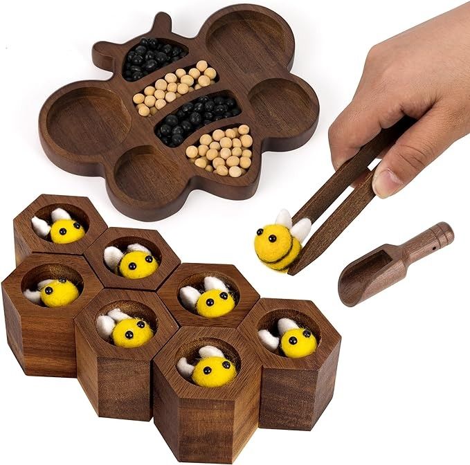 Wooden bee and hive educational toy with hand holding a felt bee using wooden tweezers.