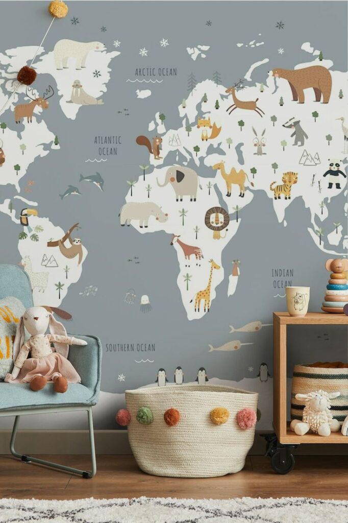 Decorative world map with illustrated animals and ocean labels, cozy nursery setting with toys and a plush chair.