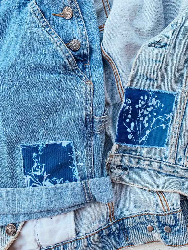 Denim jackets with blue floral patches, showcasing sustainable fashion and creative DIY upcycling designs.