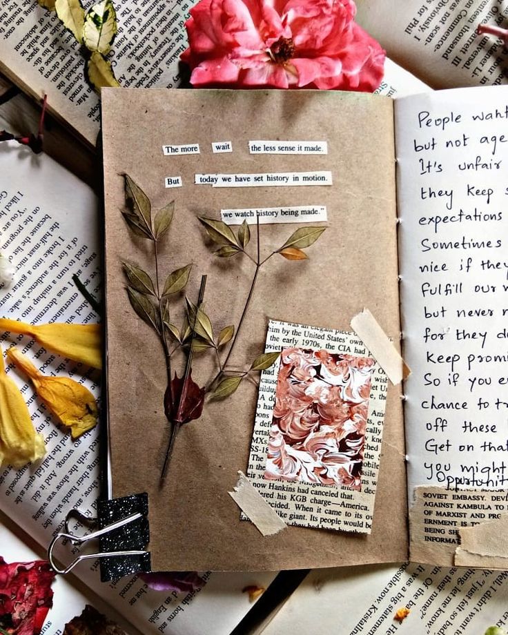 Open journal with dried leaves, poetry clippings, and a pink rose on pages for creative inspiration.