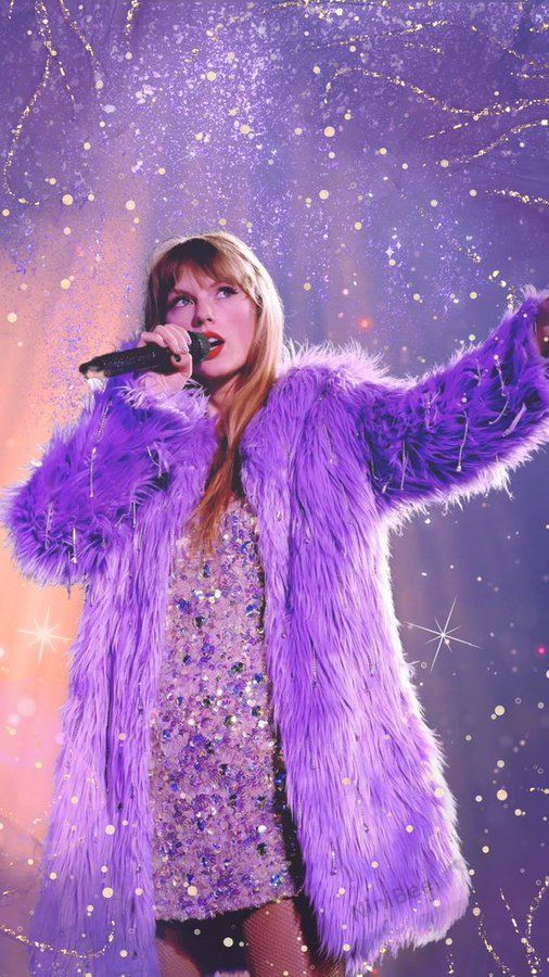 Singer performing on stage in a sparkling dress and purple fur coat with a glittery, enchanting background.