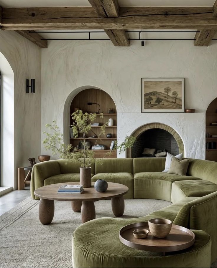 Stylish living room with green velvet sofa, wooden coffee table, and rustic fireplace. Cozy, modern interior design.