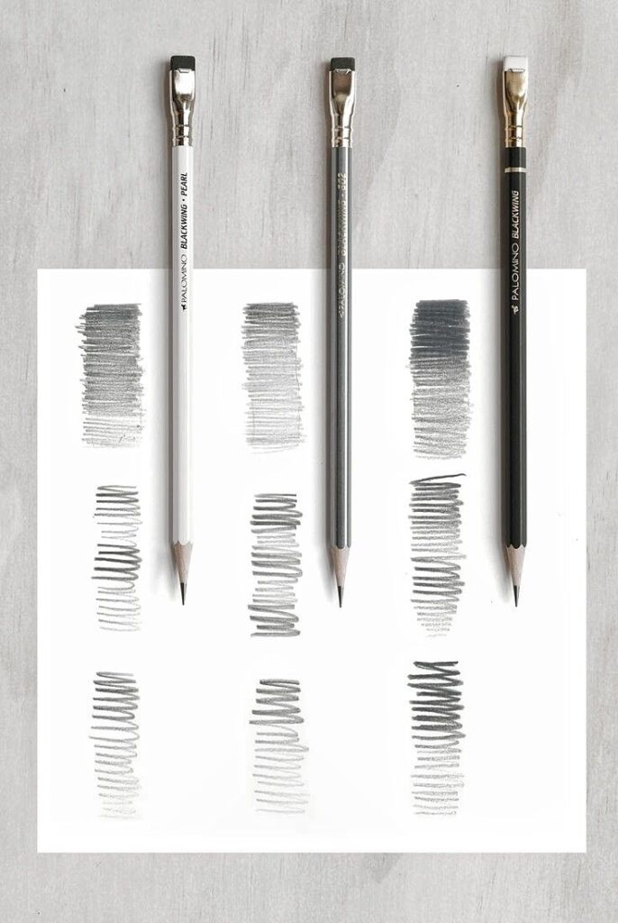 Three pencils with different shades and line thicknesses on a sheet. Perfect for art and sketching comparisons.