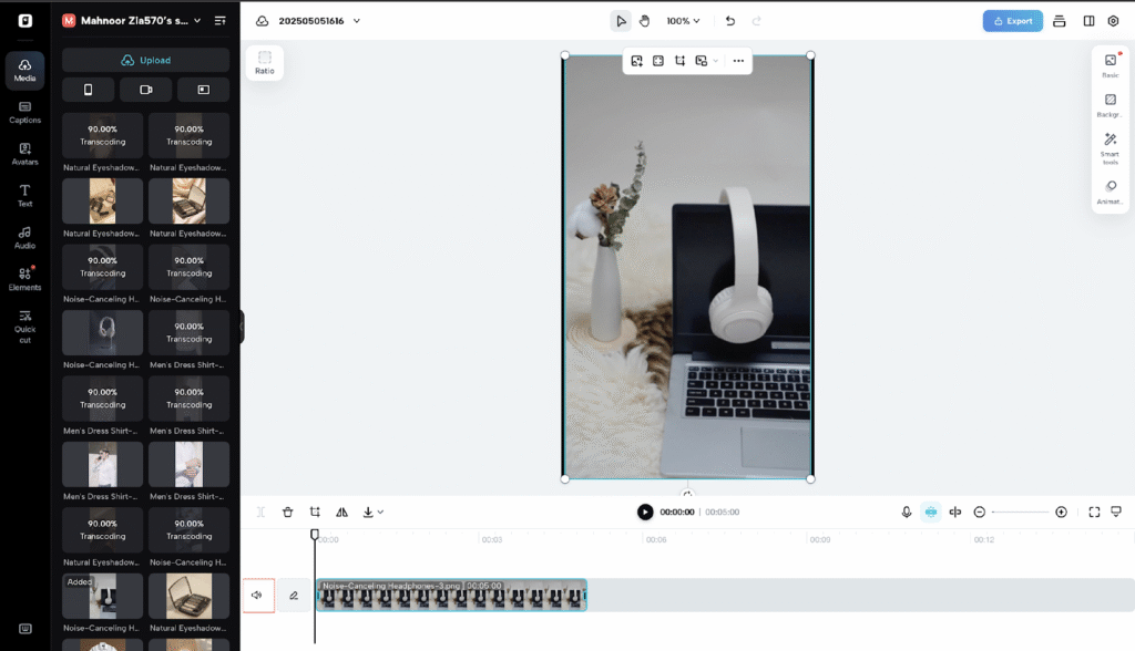 Alt text: Noise-canceling headphones on laptop with decorative flowers nearby, minimal workspace setup.