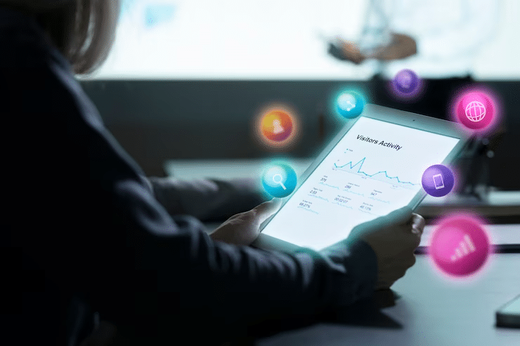 Person analyzing digital metrics on a tablet with colorful tech icons representing online data.
