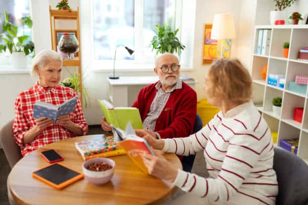 istockphoto-1148246361-612x612 Seniors enjoying a lively book club meeting in a cozy, well-lit room with plants and colorful books. | Sky Rye Design Seniors enjoying a lively book club meeting in a cozy, well-lit room with plants and colorful books.
