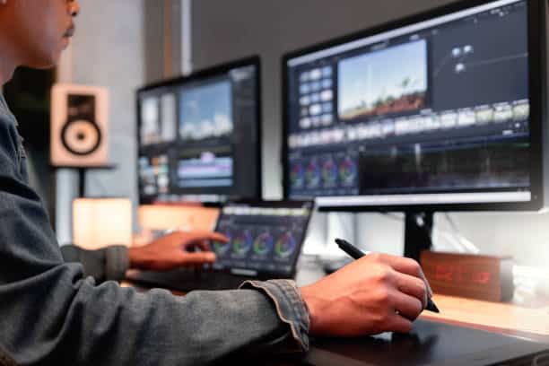 istockphoto-2037853922-612x612 Video editor working with dual monitors, adjusting color grading on a digital tablet in a modern, tech-savvy workspace. | Sky Rye Design Video editor working with dual monitors, adjusting color grading on a digital tablet in a modern, tech-savvy workspace.
