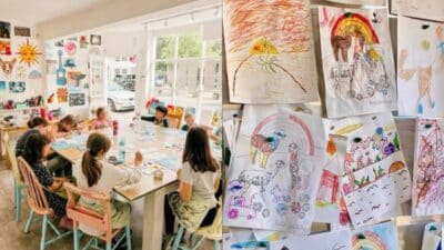 Children's art class with colorful drawings displayed on the wall; kids engaged in creative activities.