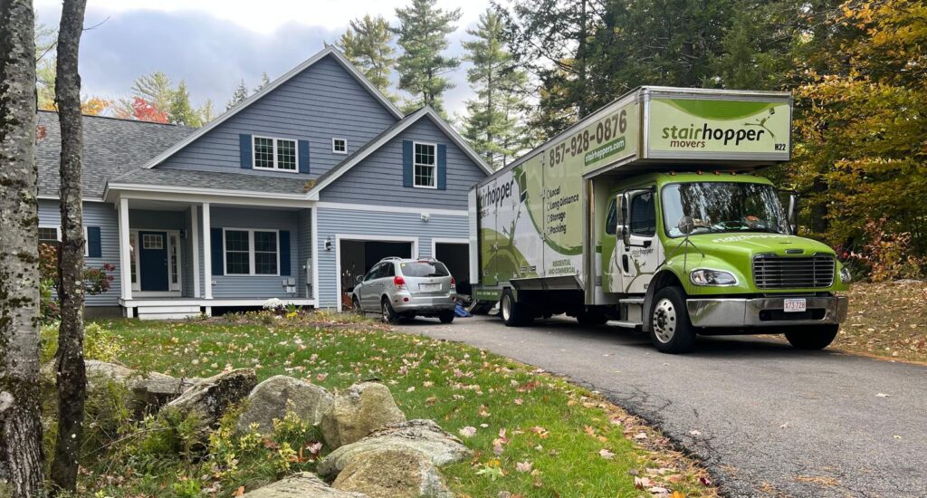 old truck at home Green moving truck parked in driveway of blue house surrounded by autumn trees. | Sky Rye Design Green moving truck parked in driveway of blue house surrounded by autumn trees.