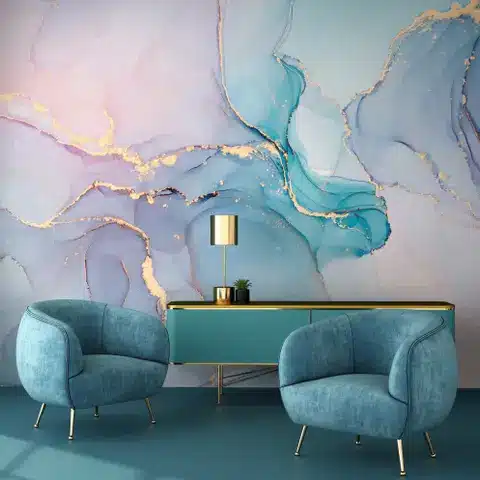 ss1894016554-1_1 Two blue armchairs and a console table against a pastel abstract wall with gold accents. | Sky Rye Design Two blue armchairs and a console table against a pastel abstract wall with gold accents.