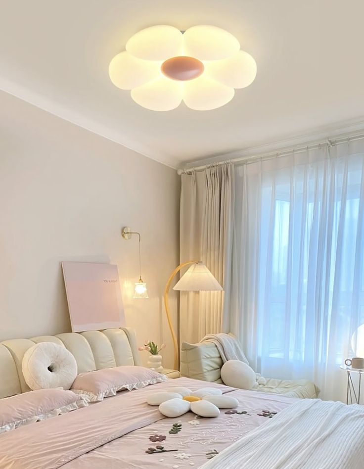 Modern bedroom with floral decor, soft lighting, and a flower-shaped ceiling lamp for a cozy, elegant atmosphere.